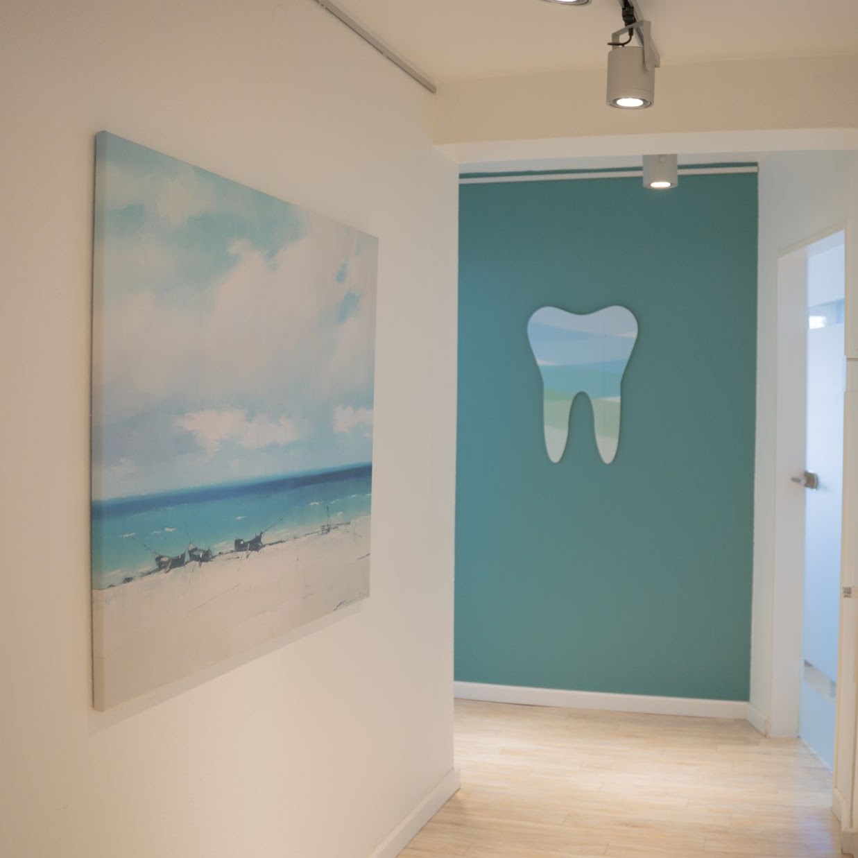 Heller Praxisflur mit Wandkunst und Zahn-Motiv